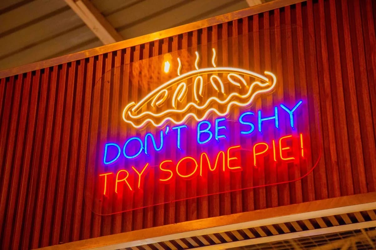 Neon sign reading Don't be shy, try some pie